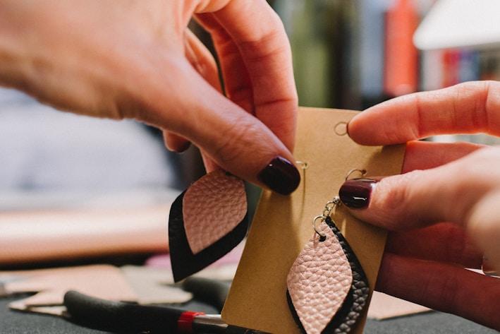 pair of white-and-black leather teardrop earrings