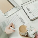 A professional organizing the week with detailed schedule planners in an office setting.